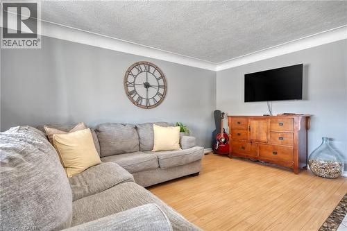 Living area featuring light wood-finish flooring, light gray walls, and white crown molding - 151 Winchester Boulevard, Hamilton, ON - Indoor Photo Showing Other Room