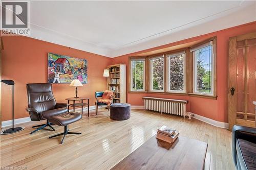 Bright living room featuring a prominent bay window, and cove molding. - 128 Wilhelm Street, Kitchener, ON - Indoor