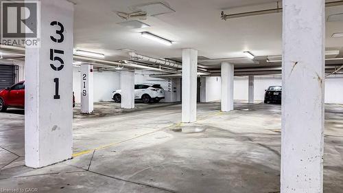 Underground parking garage featuring concrete pillars with identification numbers - 101 Shoreview Place Unit# 631, Stoney Creek, ON - Indoor Photo Showing Garage