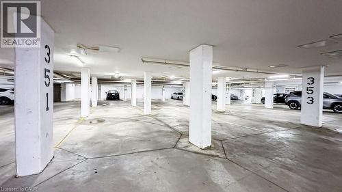 Underground parking facility featuring concrete flooring and structural pillars - 101 Shoreview Place Unit# 631, Stoney Creek, ON - Indoor Photo Showing Garage