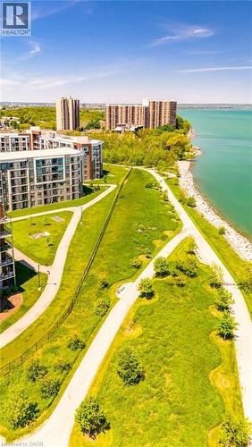 Aerial perspective showcasing contemporary multi-story buildings, expansive green spaces, and a prominent waterfront - 101 Shoreview Place Unit# 631, Stoney Creek, ON - Outdoor With Body Of Water With View