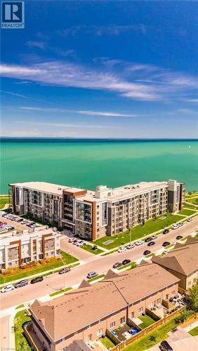 Waterfront multi-story residential building with private balconies and expansive windows - 101 Shoreview Place Unit# 631, Stoney Creek, ON - Outdoor With Body Of Water With View