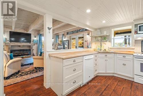5 - 1028 Oak Street, Muskoka Lakes (Medora), ON - Indoor Photo Showing Kitchen With Fireplace