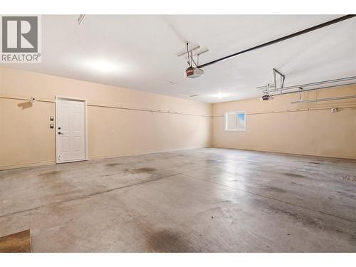 Spacious triple car garage - 448 Viewcrest Road, Kelowna, BC - Indoor Photo Showing Garage