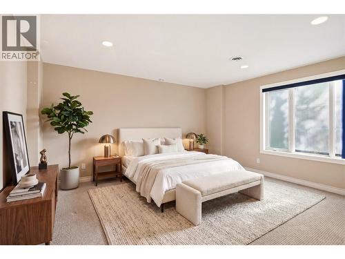 Lower level bedroom 2 with virtually staged furniture - 448 Viewcrest Road, Kelowna, BC - Indoor Photo Showing Bedroom