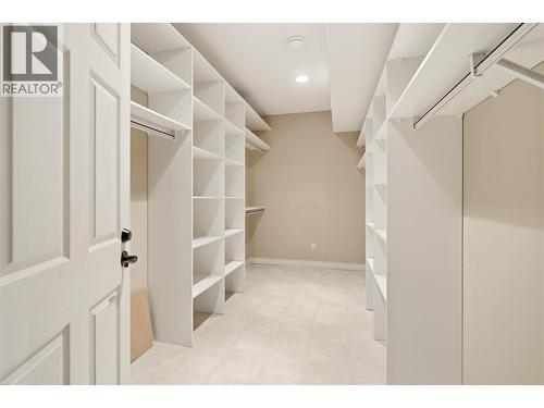 Spacious storage room with shelving off the utility room - 448 Viewcrest Road, Kelowna, BC - Indoor With Storage