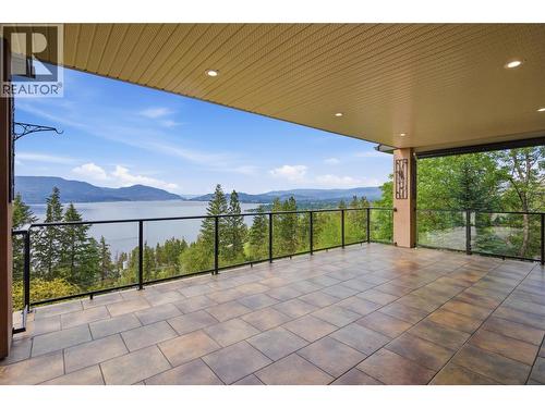 Huge covered balcony off the main floor living and family room - 448 Viewcrest Road, Kelowna, BC - Outdoor With Body Of Water With Deck Patio Veranda With View With Exterior