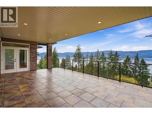 Covered balcony off the main floor living and family room - 448 Viewcrest Road, Kelowna, BC - Outdoor With Balcony With View With Exterior
