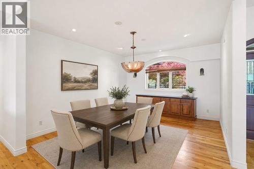 Dining room with virtually staged furniture - 448 Viewcrest Road, Kelowna, BC - Indoor Photo Showing Dining Room