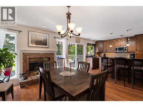 2211 Shannon Woods Place, West Kelowna, BC - Indoor Photo Showing Dining Room With Fireplace