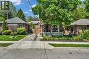 Brick-clad residence featuring a covered front porch with dark railings and stone steps - 25 Park Street E, Hamilton, ON  - Outdoor 