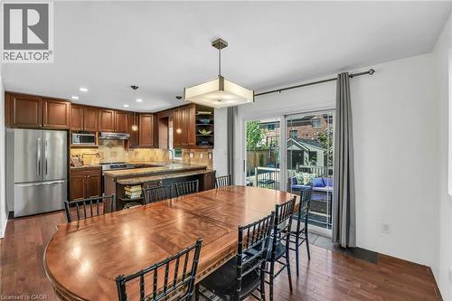 Open-concept kitchen and dining area featuring rich wood-finish flooring - 25 Park Street E, Hamilton, ON - Indoor Photo Showing Dining Room
