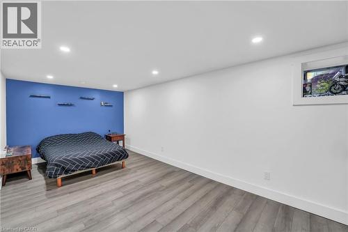 Room featuring wood-finish flooring, recessed lighting, and a window with a white frame - 25 Park Street E, Hamilton, ON - Indoor