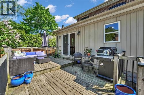 Multi-level wood deck featuring vertical siding exterior, a sliding glass door, and a single-pane window - 25 Park Street E, Hamilton, ON - Outdoor With Deck Patio Veranda With Exterior