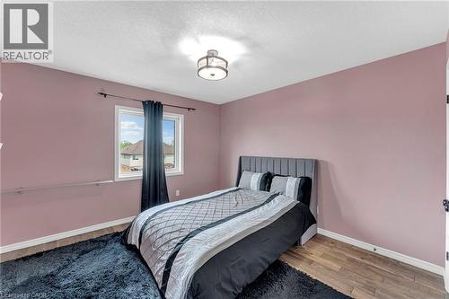 Bedroom featuring wood-finish flooring, a single window, and a ceiling-mounted light fixture - 139 Ferris Drive, Wellesley, ON - Indoor Photo Showing Bedroom