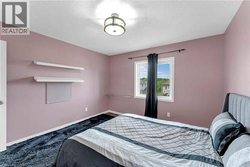 Bedroom with pink walls, white trim, and wood-finish flooring - 139 Ferris Drive, Wellesley, ON - Indoor Photo Showing Bedroom