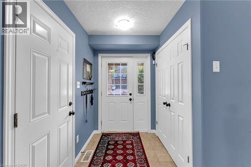 Entryway featuring a white paneled door, a sidelight with muntins, and a complementary white paneled closet door - 139 Ferris Drive, Wellesley, ON - Indoor Photo Showing Other Room