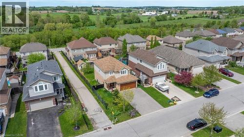 Residential street featuring a collection of detached homes, green lawns, and paved driveways - 139 Ferris Drive, Wellesley, ON - Outdoor With View