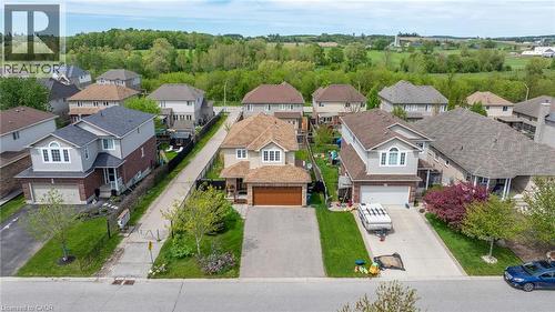 Suburban neighborhood featuring a variety of detached homes with distinct architectural styles, individual driveways, and landscaped front yards - 139 Ferris Drive, Wellesley, ON - Outdoor With Facade