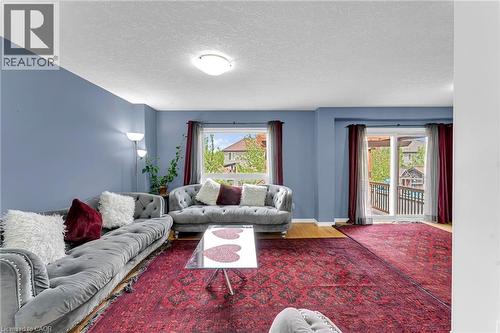 Living area featuring light blue walls and hardwood-finish flooring - 139 Ferris Drive, Wellesley, ON - Indoor Photo Showing Living Room