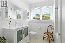 White vanity with frosted glass cabinet doors and chrome pulls - 