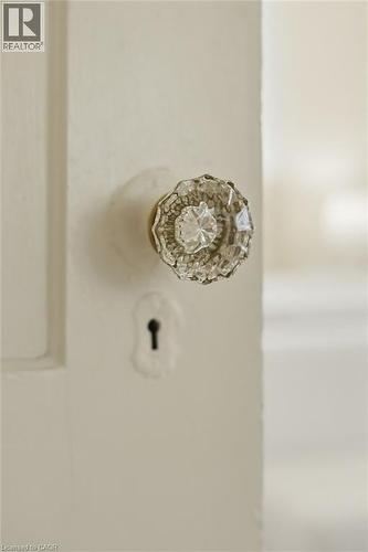 White painted door with a faceted glass doorknob and visible keyhole - 314 Hess Street S, Hamilton, ON - 