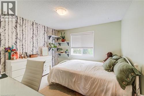Interior room featuring a white dresser, wall-mounted shelving, and a window with blinds - 702 Elgin Street N, Cambridge, ON - Indoor Photo Showing Bedroom