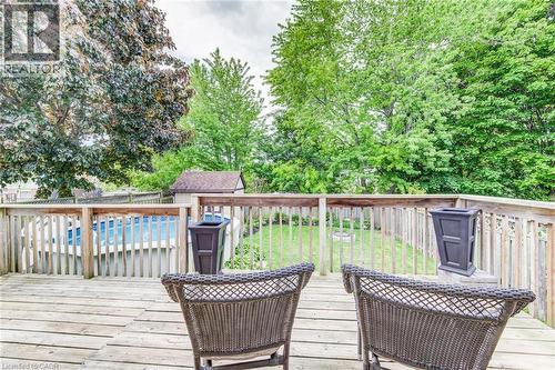 Expansive wooden deck overlooking a fenced backyard with an above-ground pool, a storage shed, and mature trees - 702 Elgin Street N, Cambridge, ON - Outdoor With Deck Patio Veranda