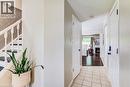 Entryway featuring ceramic tile flooring, a staircase with wood-finish treads and white balusters, and a patterned accent wall - 702 Elgin Street N, Cambridge, ON  - Indoor Photo Showing Other Room 