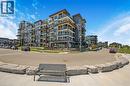 Modern multi-story building featuring expansive balconies with glass railings - 10 Esplanade Lane Unit# 310, Grimsby, ON  - Outdoor With Facade 