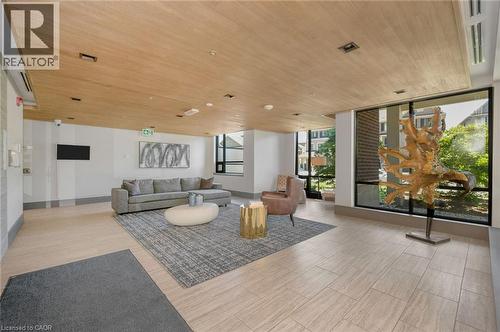 Spacious common area featuring light wood-finish ceiling, large format tile flooring, and expansive windows - 10 Esplanade Lane Unit# 310, Grimsby, ON - Indoor