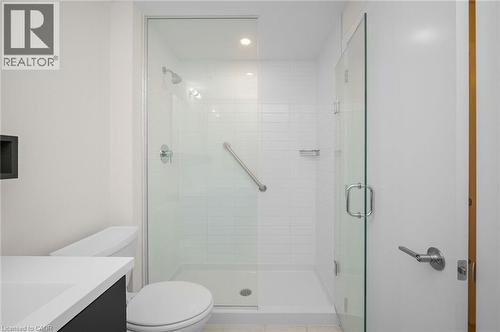 Walk-in shower with clear glass enclosure and subway tile surround - 10 Esplanade Lane Unit# 310, Grimsby, ON - Indoor Photo Showing Bathroom