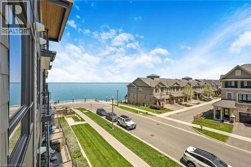Expansive water visible from the property, featuring a paved waterfront pathway - 10 Esplanade Lane Unit# 310, Grimsby, ON - Outdoor With Body Of Water