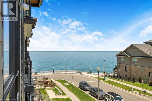 Waterfront setting with expansive water frontage and a paved road - 10 Esplanade Lane Unit# 310, Grimsby, ON - Outdoor With Body Of Water