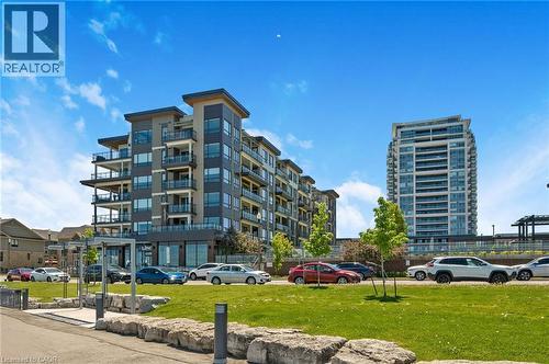 Modern multi-story building featuring dark gray and light gray facade panels - 10 Esplanade Lane Unit# 310, Grimsby, ON - Outdoor With Facade
