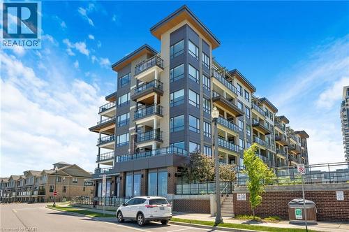 Contemporary multi-story building featuring dark paneling and light-toned accents - 10 Esplanade Lane Unit# 310, Grimsby, ON - Outdoor With Facade