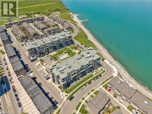 Aerial perspective showcasing multi-story residential buildings situated along a waterfront - 10 Esplanade Lane Unit# 310, Grimsby, ON -  With Body Of Water With View
