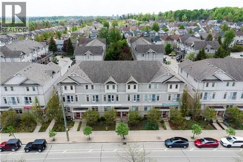 Contemporary townhome exteriors featuring light gray siding and dark gray shingled roofs - 619 Wild Ginger Avenue Unit# C15, Waterloo, ON - Outdoor With Facade