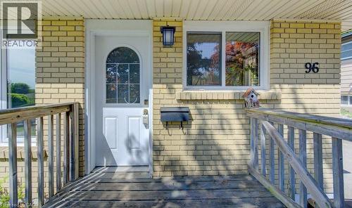 Brick exterior featuring a white arched-window entry door - 96 Scott Road, Cambridge, ON - Outdoor With Deck Patio Veranda With Exterior