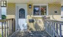 Brick exterior featuring a white arched-window entry door - 96 Scott Road, Cambridge, ON  - Outdoor With Deck Patio Veranda With Exterior 