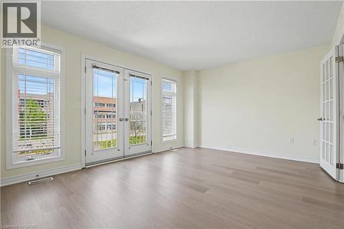 Spacious room featuring wood-finish flooring, light-toned walls, and a white ceiling - 619 Wild Ginger Avenue Unit# C16, Waterloo, ON - Indoor Photo Showing Other Room