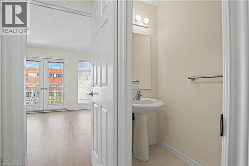 Bright room featuring double French doors, a window with horizontal blinds, and wood-finish flooring - 619 Wild Ginger Avenue Unit# C16, Waterloo, ON - Indoor Photo Showing Bathroom