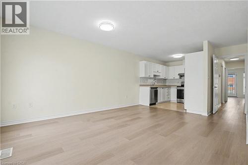 Open concept living area featuring wood-finish flooring, recessed lighting, and a neutral color palette - 619 Wild Ginger Avenue Unit# C16, Waterloo, ON - Indoor