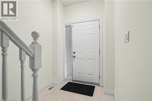 Entryway featuring a paneled door with a sidelight, a painted baluster, and neutral wall tones - 619 Wild Ginger Avenue Unit# C16, Waterloo, ON - Indoor Photo Showing Other Room
