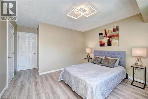 Light wood-finish flooring complements the neutral wall color - 92 Pinemeadow Crescent, Waterloo, ON - Indoor Photo Showing Bedroom