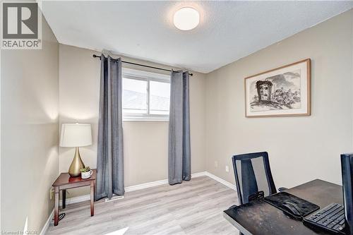 Recessed lighting, neutral wall tones, and light wood-finish flooring define this versatile room - 92 Pinemeadow Crescent, Waterloo, ON - Indoor
