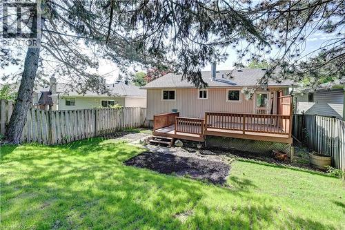Expansive backyard featuring a multi-level wooden deck with railing, a grassy lawn, and a privacy fence - 92 Pinemeadow Crescent, Waterloo, ON - Outdoor With Deck Patio Veranda