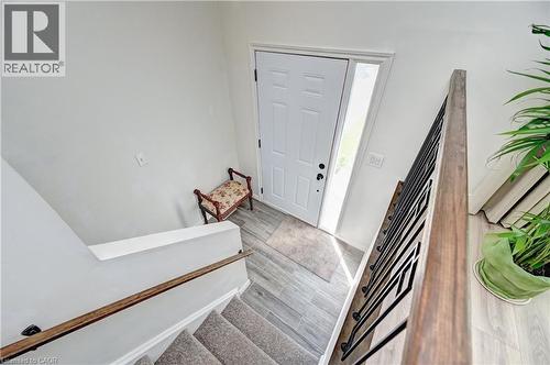 Entryway featuring a paneled door, vertical window, and wood-finish tile flooring - 92 Pinemeadow Crescent, Waterloo, ON - Indoor Photo Showing Other Room