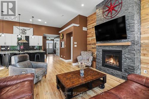 Dramatic floor-to-ceiling stone fireplace - 766 Du Rivage Street, Clarence-Rockland, ON - Indoor Photo Showing Living Room With Fireplace