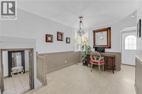 Entryway featuring tile flooring, wainscoting, a prominent window with blinds, and a decorative pendant light fixture - 1 Galbraith Drive, Hamilton, ON - Indoor